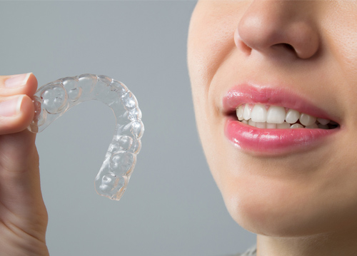 clear aligner and woman smiling